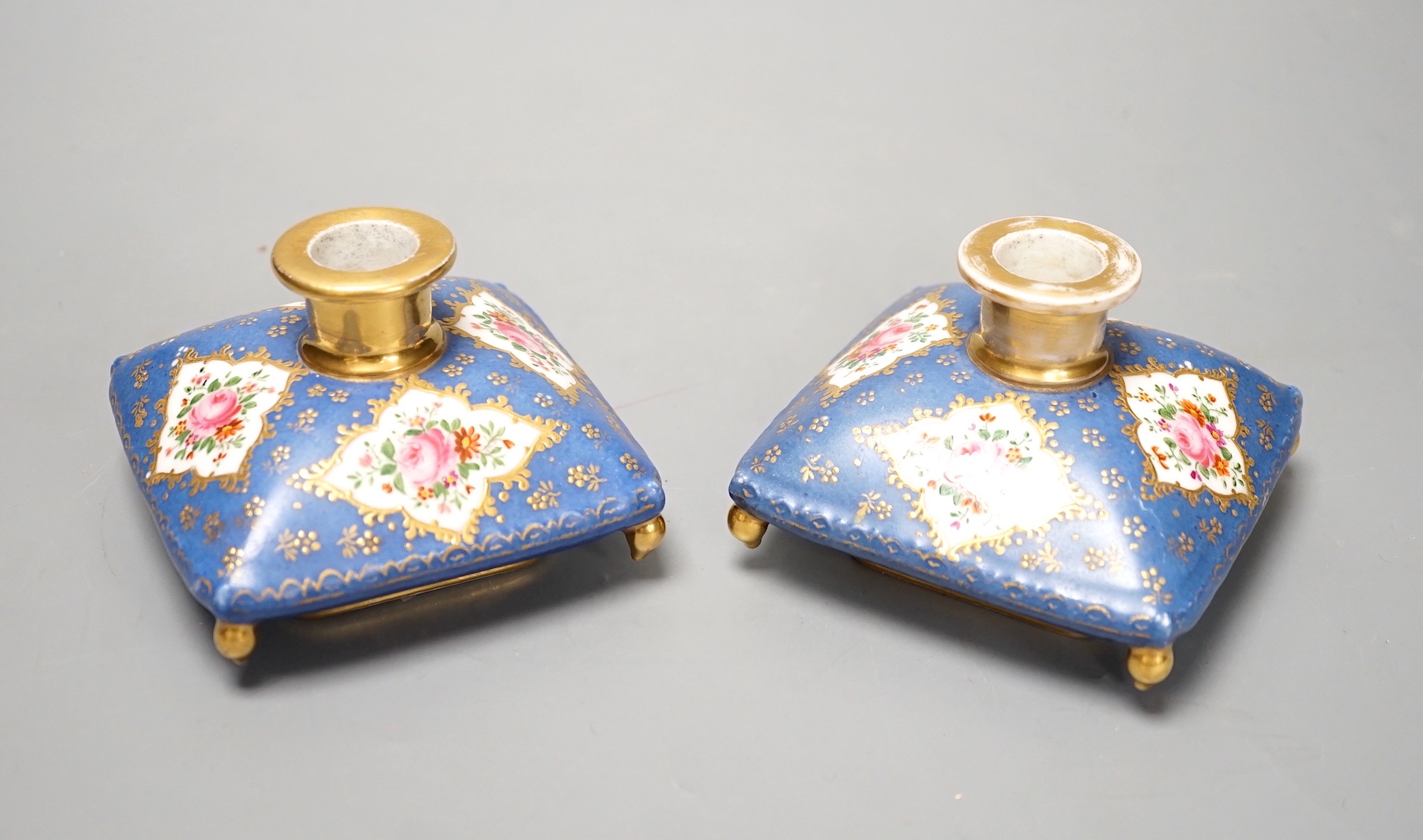 A pair of mid 19th century Paris porcelain 'cushion' shaped scent bottles decorated in Sevres style with pink roses (lacking stoppers)